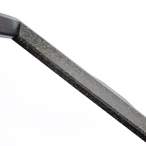 May include: Close-up of a black metal bar with a textured surface.