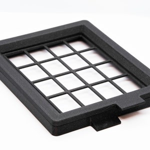 May include: Black plastic frame with a grid pattern. The frame is about 10 inches wide and 7 inches tall.