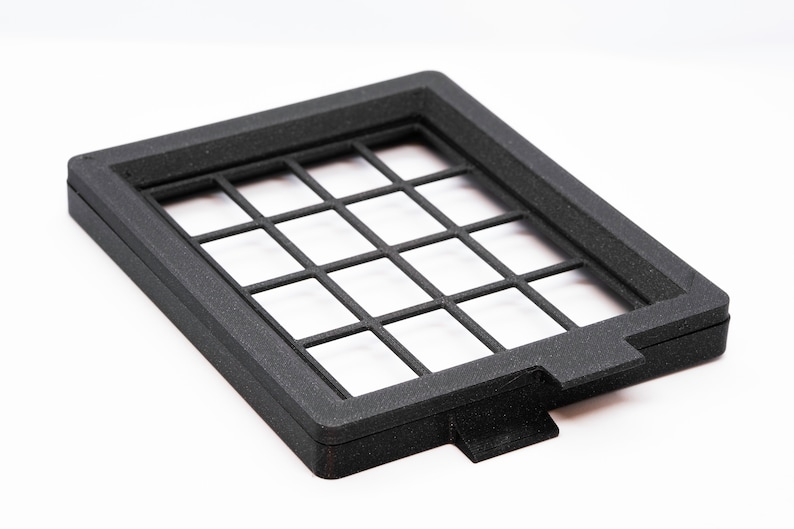 May include: Black plastic frame with a grid pattern. The frame is about 10 inches wide and 7 inches tall.