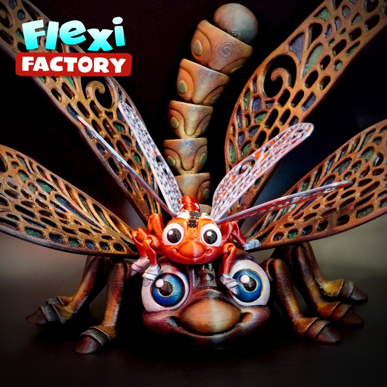 May include: A detailed 3D-printed dragonfly model with a cartoonish design. The insect features large, blue-eyed eyes and a smiling face. The wings are brown and gold, and the text "Flexi Factory" is visible. The sculpture is on a dark background.