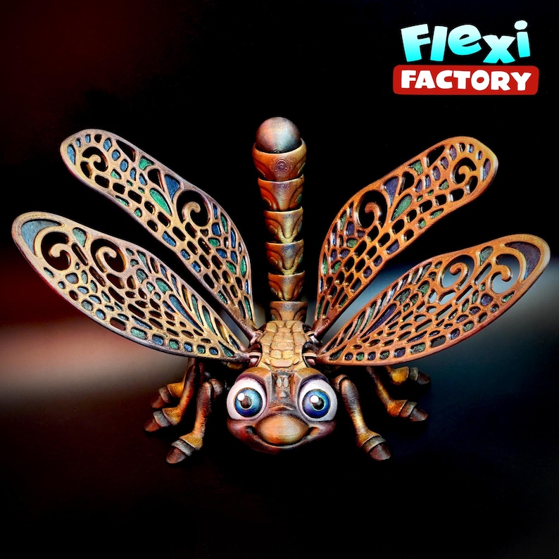 May include: A detailed, 3D-printed dragonfly sculpture with intricate wing patterns and a smiling face. The wings are a copper colour with green and blue accents. The sculpture has the text "Flexi Factory" in the upper right corner.
