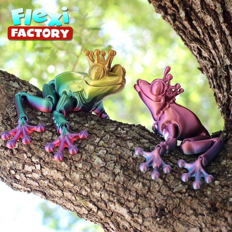 May include: Two iridescent frogs wearing crowns, sitting on a tree branch. The frog on the left is green, yellow, and purple. The frog on the right is pink and purple.