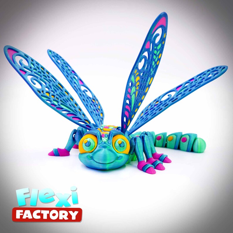 May include: A vibrant 3D-printed dragonfly model with detailed wing designs. The dragonfly has a teal body, blue wings with pink and yellow details, and pink feet. The "Flexi Factory" logo is displayed at the bottom.