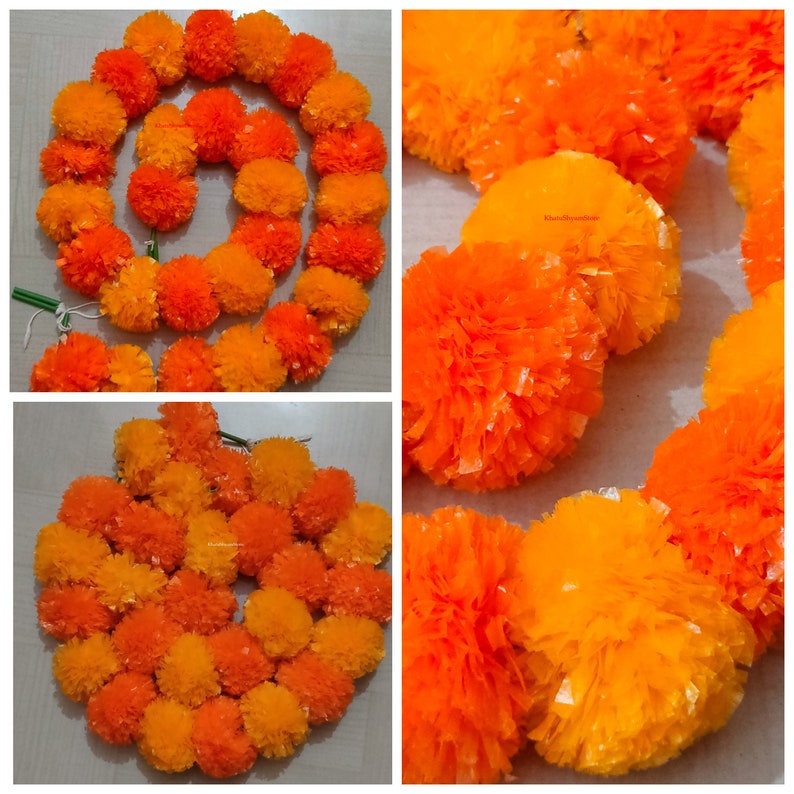 May include: A garland of orange and yellow marigold flowers made from tissue paper. The garland is made up of individual flower pom-poms.