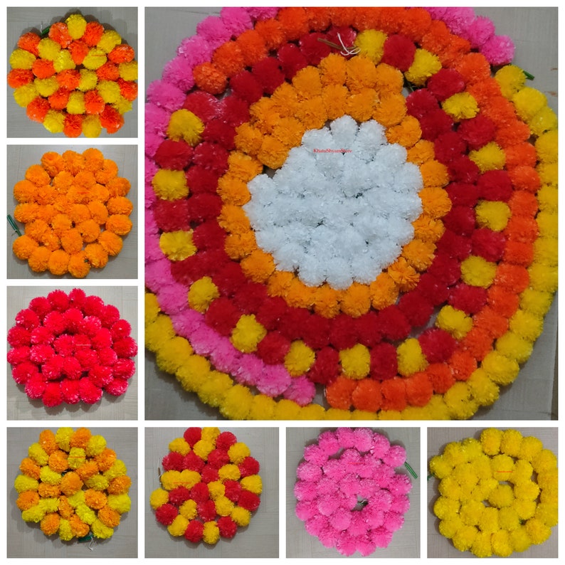 May include: A set of eight circular flower garlands made of marigold blossoms. The garlands are arranged in a grid pattern, with each garland featuring a different color combination of yellow, orange, red, pink, and white.