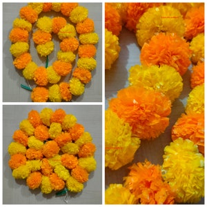 May include: A garland of yellow and orange marigold flowers, made of paper, for decoration. The garland is strung together with a green thread.