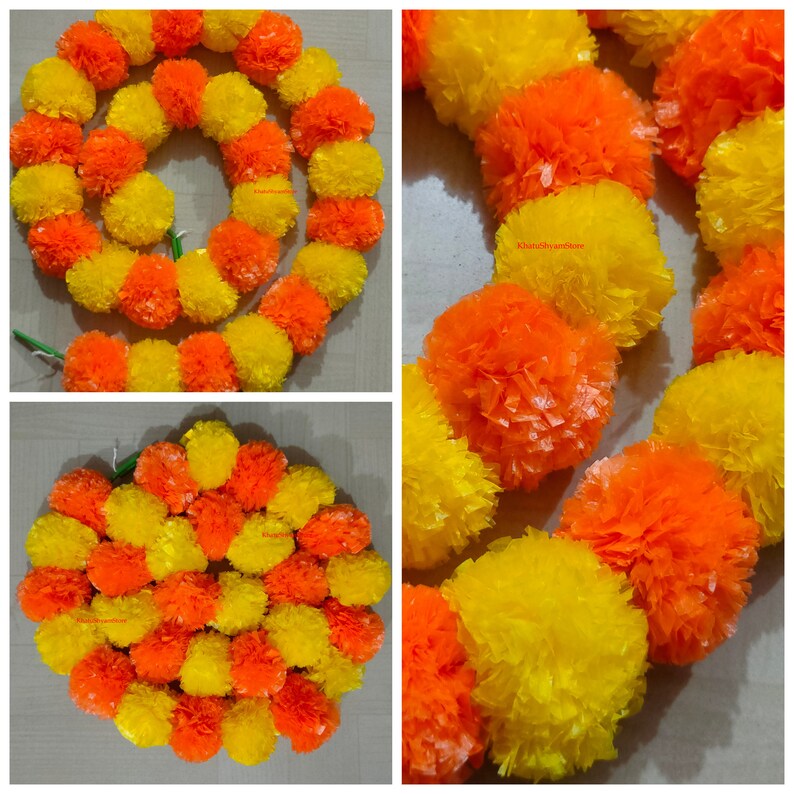 May include: A garland of yellow and orange marigold flowers, made of paper, is arranged in a circle. The garland is perfect for decorating for a special occasion or festival.