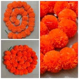 May include: A garland of orange marigold flowers, made of paper, is arranged in a circle. The garland is approximately 3 feet long and is perfect for decorating for a special occasion.