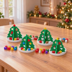May include: Four green wooden Christmas tree-shaped sorting toys on white circular bases. Each tree features cutouts for various small, colourful wooden shapes including stars, circles, squares, and holiday-themed icons like gingerbread men and snowmen.