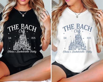 May include: Two white t-shirts with a black and blue design. The design features a castle with the text "THE BACH Club Est. 2025 Olivia's Bachelorette Party".