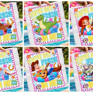May include: A collection of six white square pillows featuring colorful cartoon characters in pool floats. Each pillow displays the text YOU'VE GOT A FRIEND IN ME, surrounded by stars, balloons, horseshoes, and small animal icons in bright colors.