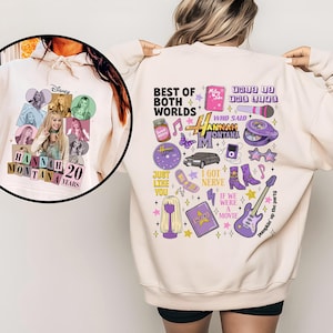 Puede incluir: Sudadera crema con un dise&ntilde;o de Hannah Montana. La parte delantera presenta un collage de fotos con "Hannah Montana 20 Years". La parte trasera tiene gr&aacute;ficos y texto, incluyendo "Best of Both Worlds" e iconos relacionados.