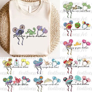 Può includere: T-shirt color crema con un design stravagante di fasce per le orecchie di topo con vari elementi a tema. La maglietta include la frase "Go live your dream" e altre frasi. Il design è ambientato su un cesto intrecciato.