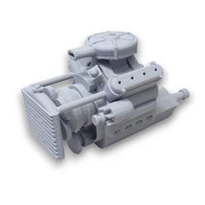 May include: A gray, 3D-printed model of an internal combustion engine. The model features detailed components, including a radiator, cylinders, and a carburetor. The engine is designed with a realistic appearance, showcasing the intricate parts of an automobile engine.