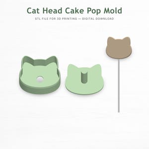 Puede incluir: Un molde para cake pops con forma de cabeza de gato verde claro con un cake pop a juego en un palito. El molde es de plástico y está diseñado para impresión 3D. El texto "Cat Head Cake Pop Mold" está en la parte superior.