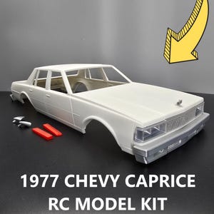 May include: White 1977 Chevy Caprice RC model kit. The kit includes the car body, wheels, and other parts.  The car is a classic American muscle car.