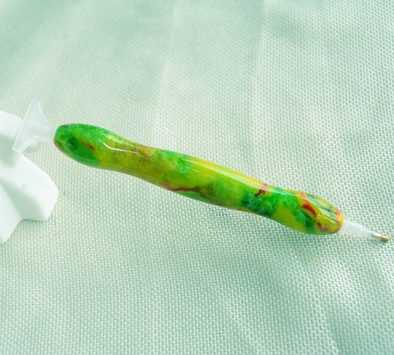 May include: A green, yellow, and red diamond painting pen with a clear plastic tip.