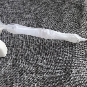 May include: A white diamond painting pen with a clear plastic barrel and a gold tip.