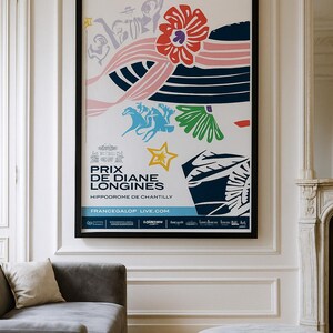 May include: A framed poster with a black border, featuring a colourful abstract design. The poster includes the text "PRIX DE DIANE LONGINES" and "FRANCEGALOP LIVE.COM". The artwork incorporates floral and geometric shapes in red, blue, pink, and yellow.