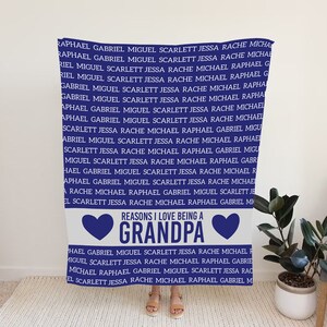 May include: Blue and white throw blanket with the text "Reasons I Love Being a Grandpa" and a heart on each side of the text. The blanket has a repeating pattern of names in blue text.