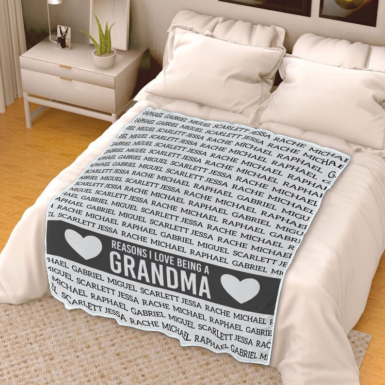 May include: A gray and white blanket with the text "Reasons I love being a Grandma" and a heart design. The text is surrounded by a repeating pattern of names, including Raphael, Gabriel, Miguel, Scarlett, Jessa, and Rache.