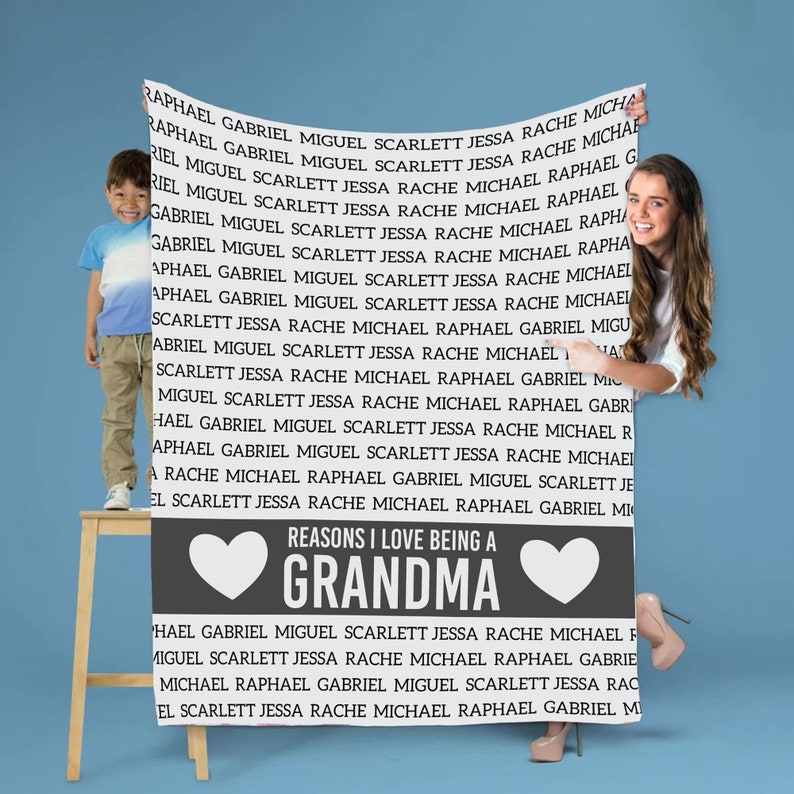 May include: A gray and white throw blanket with a heart design and the text "Reasons I love being a Grandma". The text is surrounded by a list of names, including Raphael, Gabriel, Miguel, Scarlett, Jessa, Rache, and Michael.