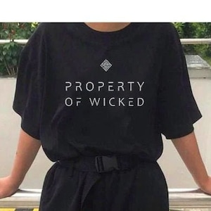 May include: Black t-shirt with white text that reads "PROPERTY OF WICKED".