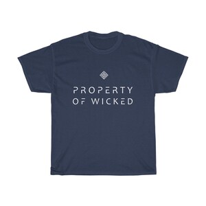 May include: A navy blue t-shirt with a white geometric design and the text "PROPERTY OF WICKED" in white.