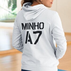 May include: White hooded sweatshirt with black text that reads "MINHO A7".
