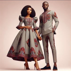 May include: A couple wearing matching gray and red patterned outfits. The woman is wearing a dress with a full skirt and the man is wearing a long-sleeved shirt and pants.