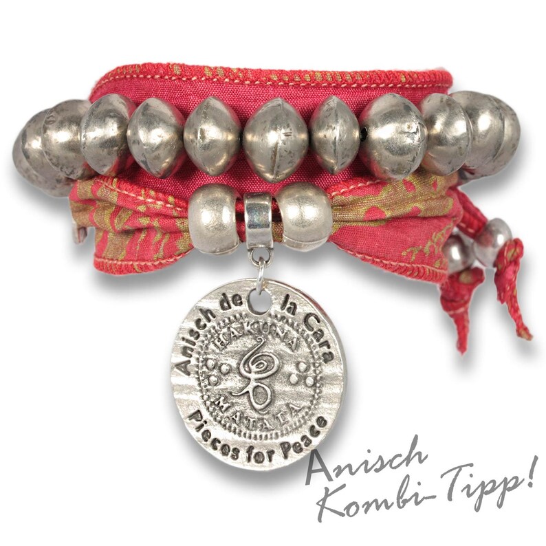 May include: A red and gold fabric bracelet with silver beads and a silver charm that says "Anisch de la Cara Pisces for Peace".