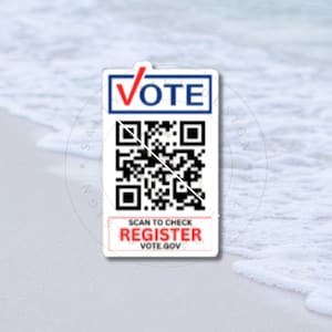 May include: A white sticker with a red checkmark and the word "VOTE" in red letters. The sticker has a black and white QR code with the text "SCAN TO CHECK REGISTER VOTE.GOV" below it.