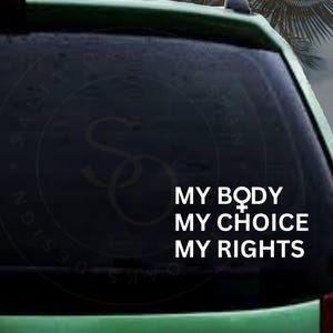 May include: A black car window with a white vinyl sticker that reads "MY BODY MY CHOICE MY RIGHTS". The sticker also includes the female gender symbol.