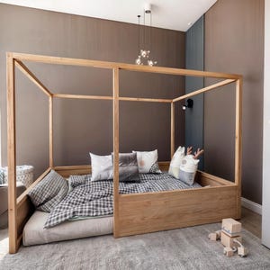 May include: A wooden canopy bed frame with a checkered duvet and pillows. The bed is in a room with brown walls and a rug on the floor.