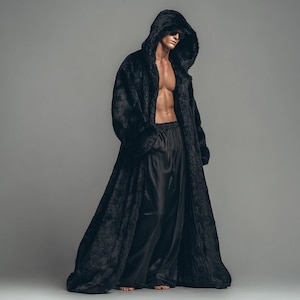 May include: A full-length black faux fur hooded coat with a matching black satin bottom. The coat has a long, flowing design with large pockets. The model is wearing sunglasses.