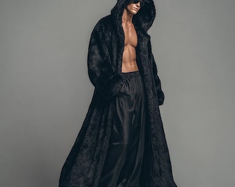 May include: A full-length black faux fur hooded coat with a matching black satin bottom. The coat has a long, flowing design with large pockets. The model is wearing sunglasses.