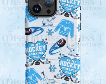 May include: A white phone case with a repeating pattern of blue hockey-themed graphics. The design includes hockey jerseys, skates, pucks, snowflakes, and hearts with the text "IN MY HOCKEY ROMANCE ERA."