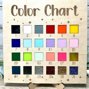 May include: A wooden color chart with 24 different colored squares. The squares are numbered 1 through 24. The chart is titled "Color Chart" and has a small wooden stand.