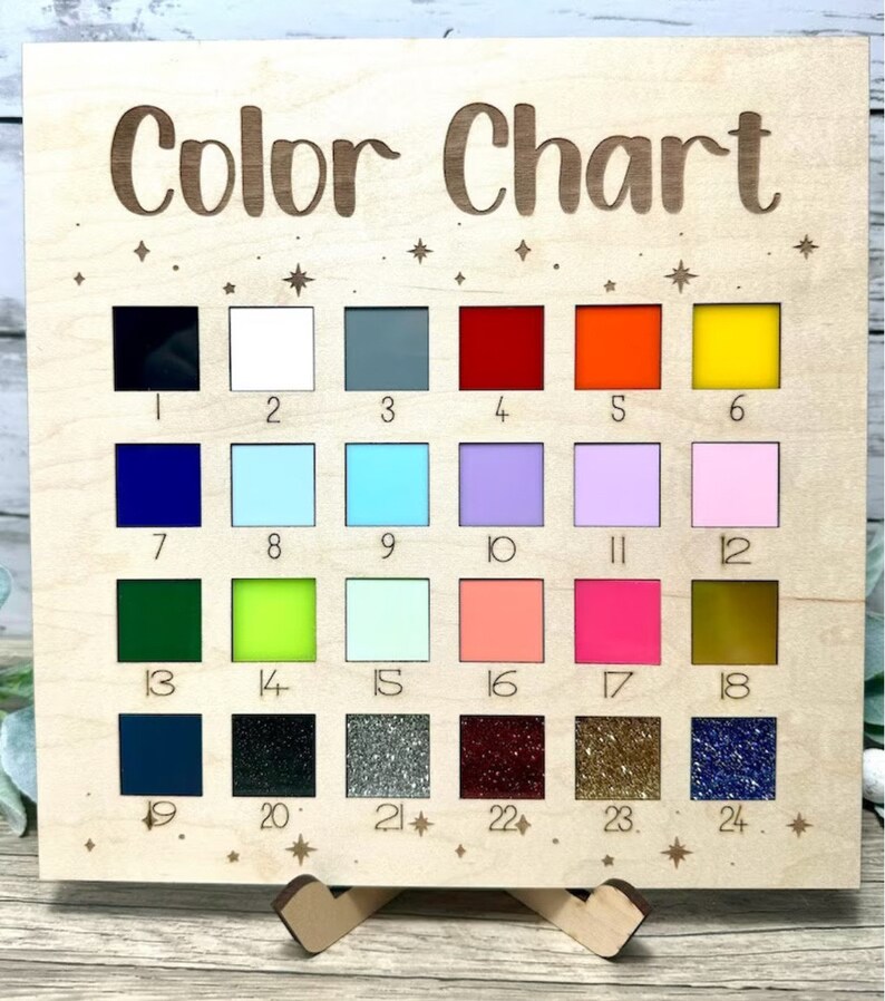 May include: A wooden color chart with 24 different colored squares. The squares are numbered 1 through 24. The chart is titled "Color Chart" and has a small wooden stand.