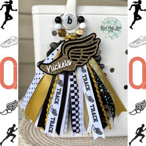 May include: Gold and black track and field themed charm with a gold winged shoe, black and white polka dot ribbon, black and white checkered ribbon, and black ribbon with gold stars and the word "TRACK" repeated on each ribbon. The charm is attached to a white and black beaded ring. The charm says "Nickels" on the shoe.