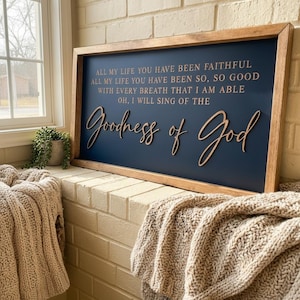 May include: A rectangular wooden sign with a dark blue background and a light brown wooden frame. The sign features the text: ALL MY LIFE YOU HAVE BEEN FAITHFUL ALL MY LIFE YOU HAVE BEEN SO, SO GOOD WITH EVERY BREATH THAT I AM ABLE OH, I WILL SING OF THE Goodness of God.