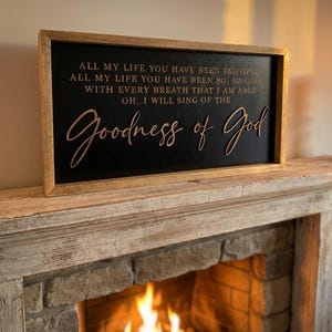 May include: A rectangular wooden sign with a light brown frame and a black background. The sign features the text: ALL MY LIFE YOU HAVE BEEN FAITHFUL, ALL MY LIFE YOU HAVE BEEN SO, SO GOOD, WITH EVERY BREATH THAT I AM ABLE, OH, I WILL SING OF THE Goodness of God.