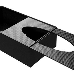 Close-up of a closed carbon fiber disposable glove dispenser, showcasing a durable and contemporary design for various environments.