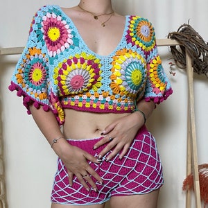 May include: A crochet top and shorts set in a bright, colorful pattern. The top is a cropped style with a V-neck and short sleeves. The shorts are a high-waisted style with a fishnet design.