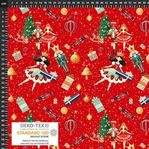 May include: A red fabric featuring a repeating Christmas pattern of nutcrackers, ballerinas in crowns, green pine trees, gift boxes, gold ornaments, and orange slices. A white OEKO-TEX Standard 100 label is visible in the bottom left corner.