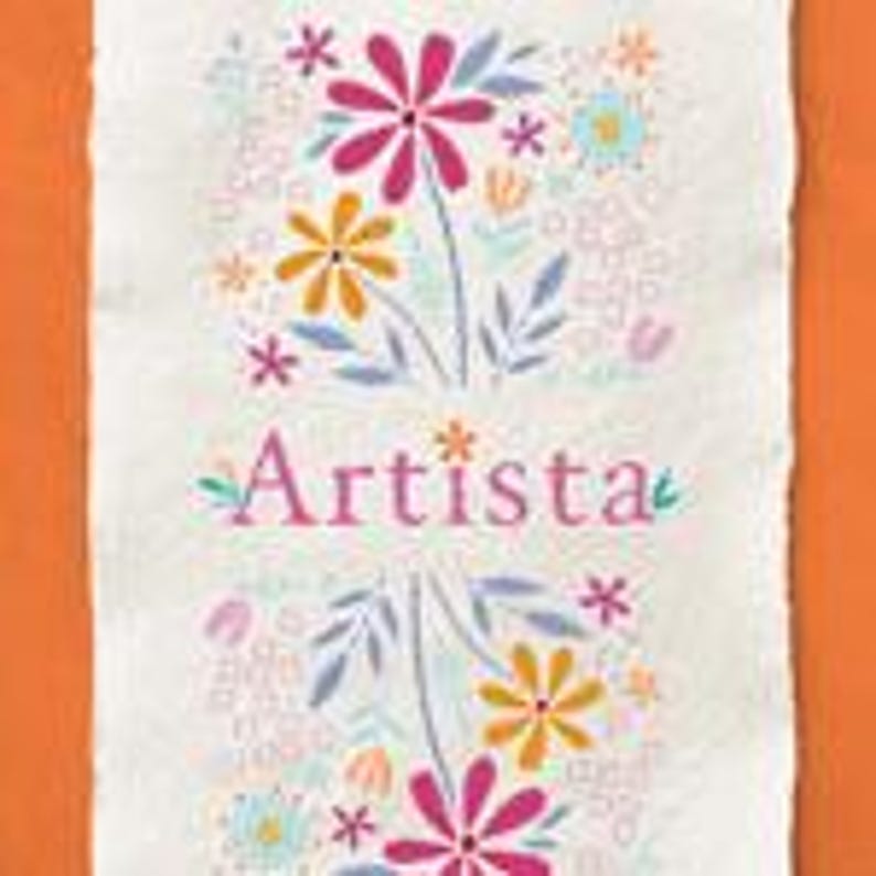 May include: A rectangular, off-white fabric with a floral design and the word "Artista" in pink script. The flowers are in shades of pink, yellow, and blue, with green leaves and stems. The background is a mix of small, light-colored floral elements.