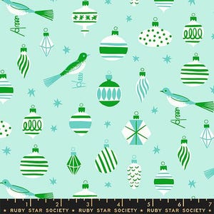 May include: A light mint green fabric featuring a repeating pattern of white and green Christmas ornaments in various shapes, small birds perched on wire springs, and tiny stars. The bottom edge includes a black border with the text RUBY STAR SOCIETY.
