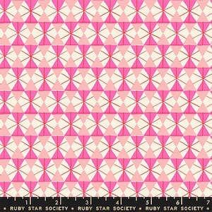 May include: A fabric print featuring a repeating geometric pattern of pink, light pink, and cream triangles arranged in circular starburst motifs with thin red lines. A black selvage edge at the bottom displays the text RUBY STAR SOCIETY and a 7-inch ruler.