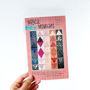 May include: A sewing pattern titled "Magical Mountains" with a quilt design featuring colorful triangles and diamonds. The pattern includes two sizes: 46" x 55" and 57" x 70". The text "Everyday Stitches" and "Patterns for everyday life" are also visible.