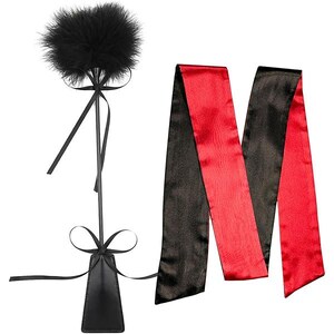 May include: A black feather teaser with a long handle and a black leather base, paired with a red and black satin blindfold. The items are designed for intimate use and are set against a white background.